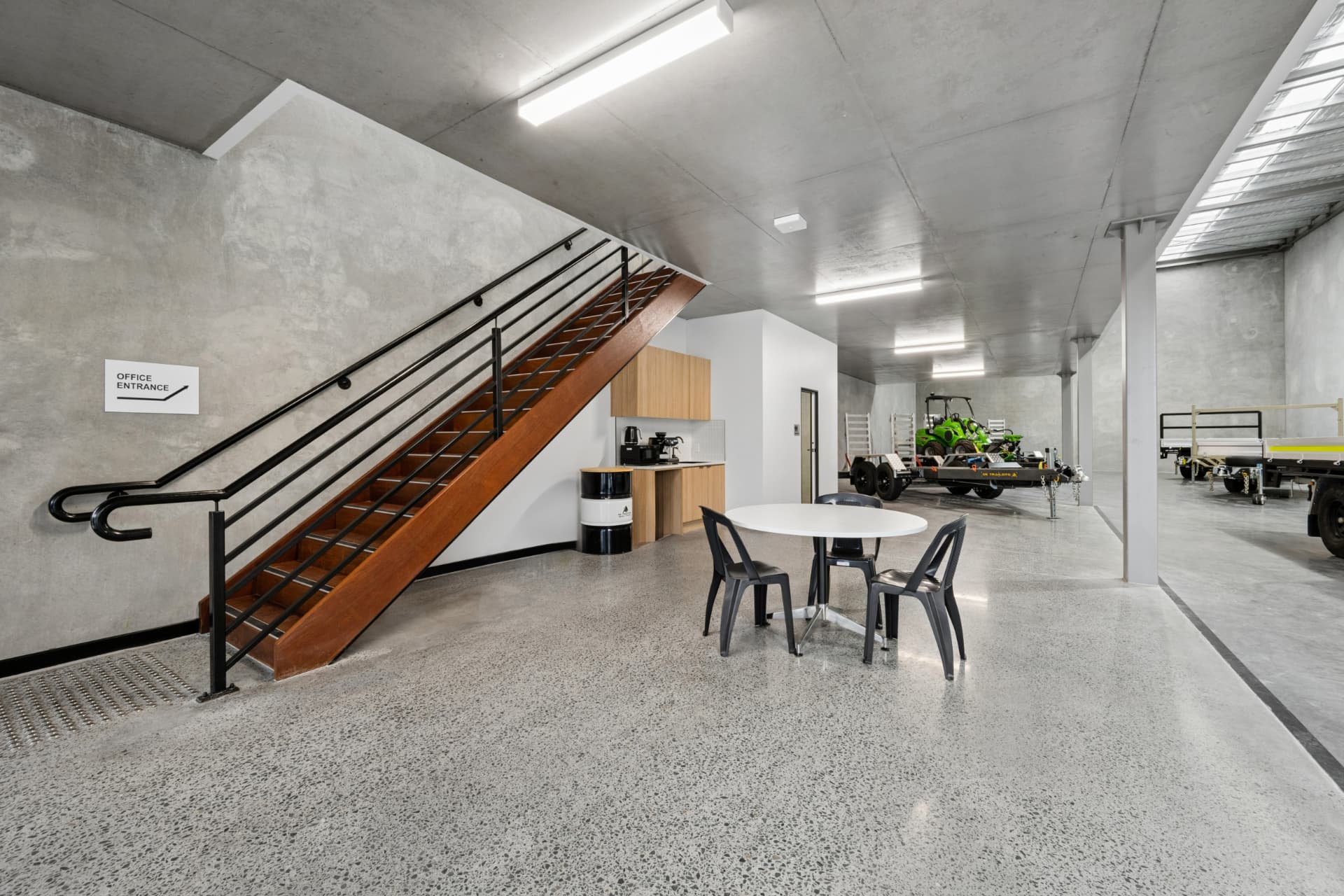 Completed industrial workplace with staircase, kitchenette and staff breakout area