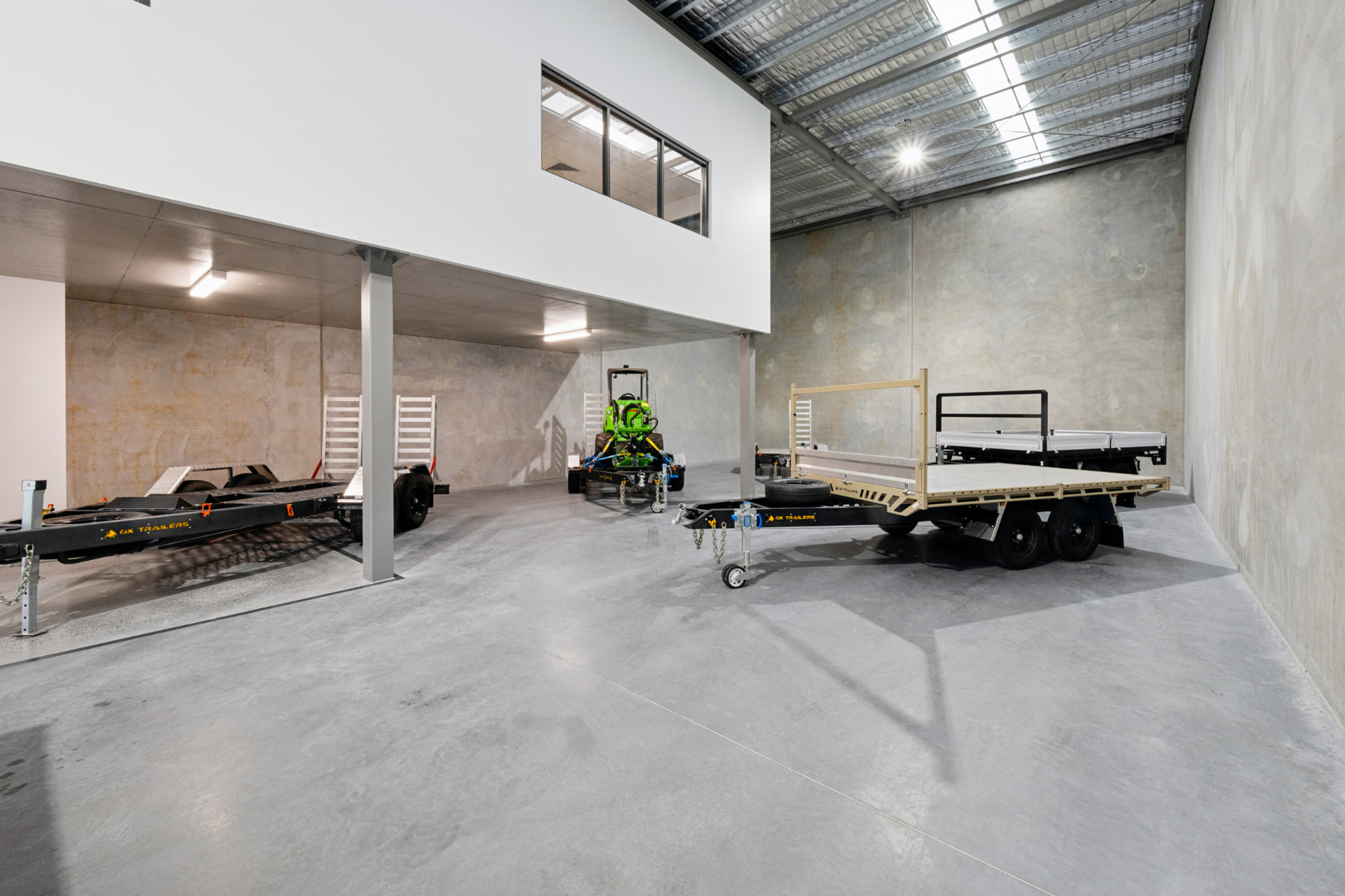 Completed high-bay industrial interior with mezzanine office and equipment floor